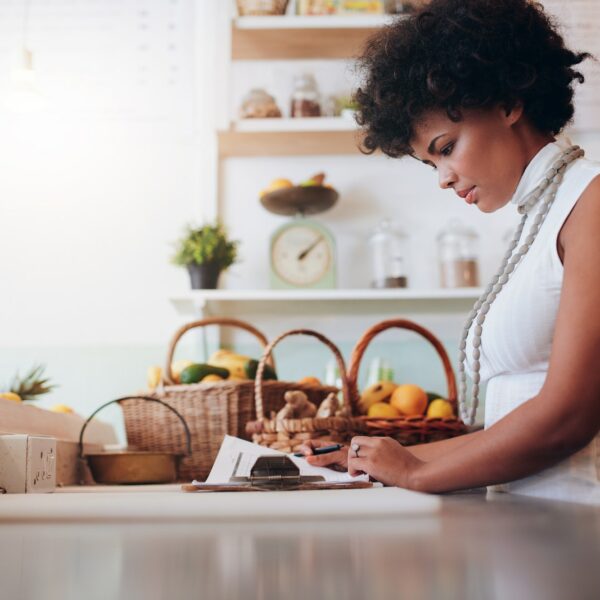 Female juice bar owner doing account