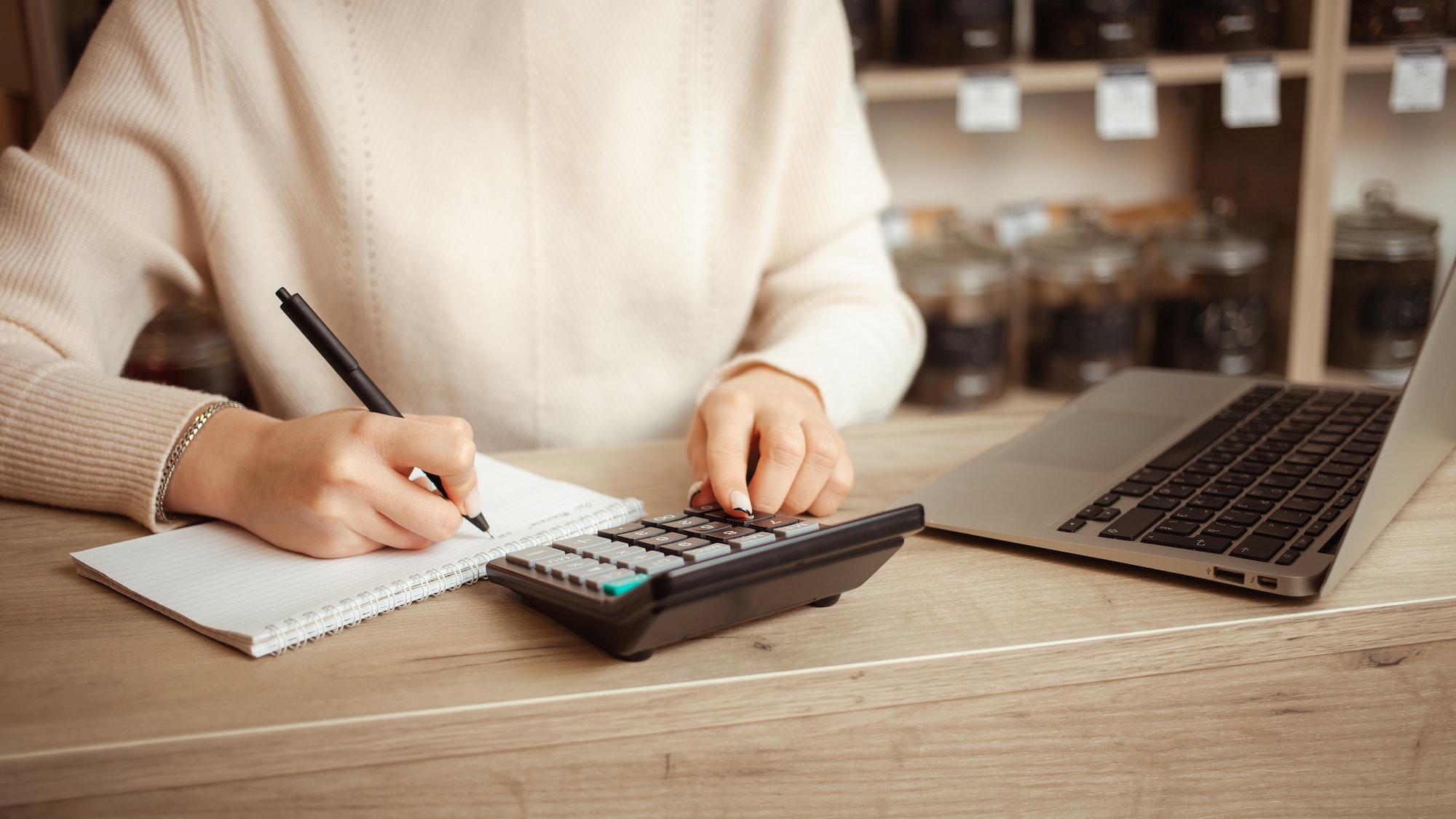 female seller in tea shop counts profits, Writes sales, keeps accounting records, small business, an