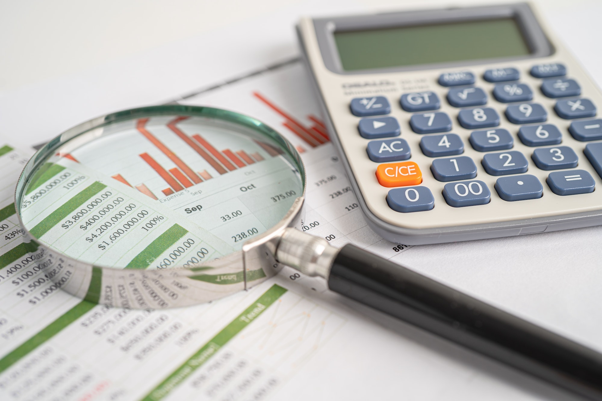 Magnifying glass on chart graph for analysis account business trade.