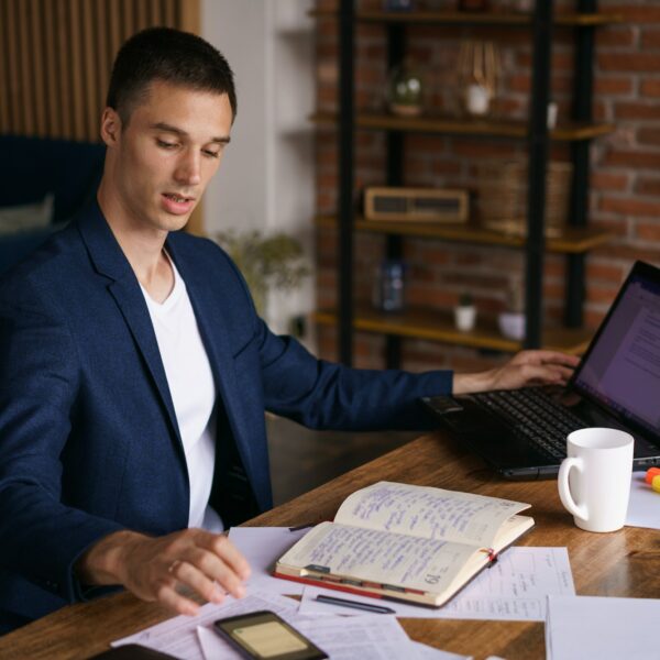 Serious caucasian businessman accountant accounting analyst holding documents